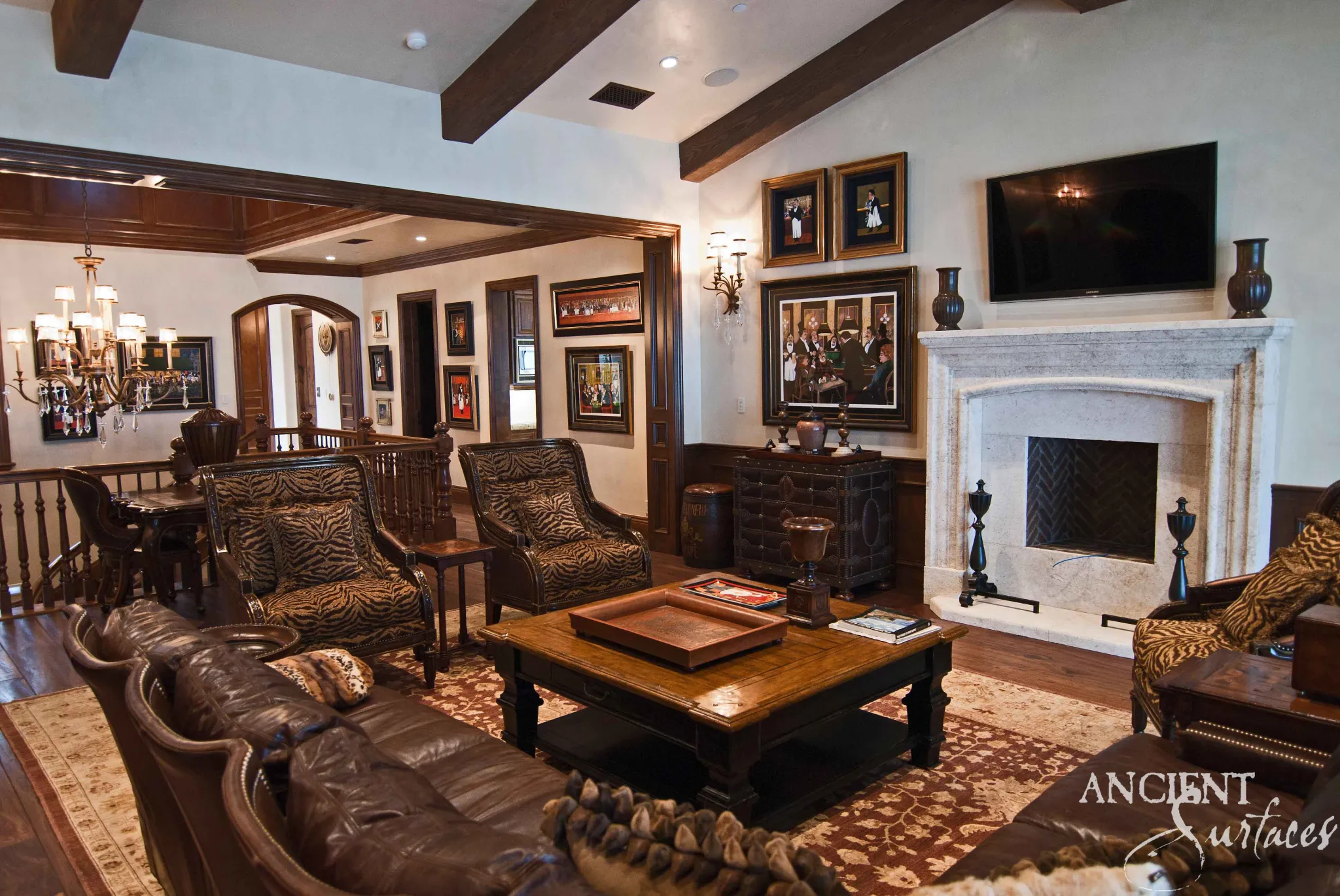 Reclaimed antique limestone fireplace mantel anchoring a warm, richly appointed room