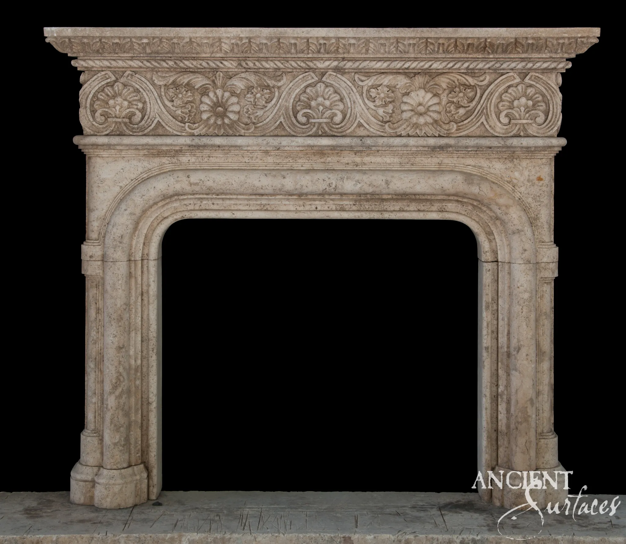 Reclaimed limestone fireplace mantel with a carved shell-and-strapwork frieze over an arched opening